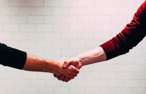 A woman and a man shaking hands