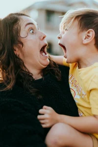 Stressed mom and young child in a tense moment, representing the emotional overwhelm of modern motherhood